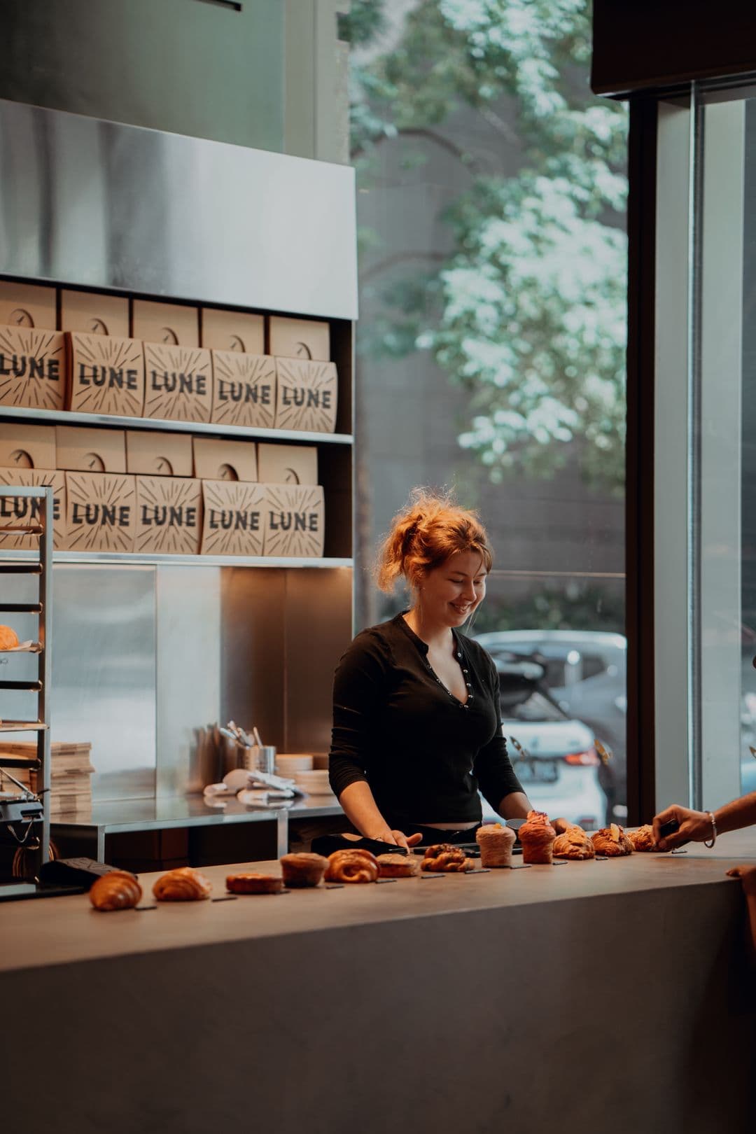 Small business owner serving customers at a Melbourne bakery