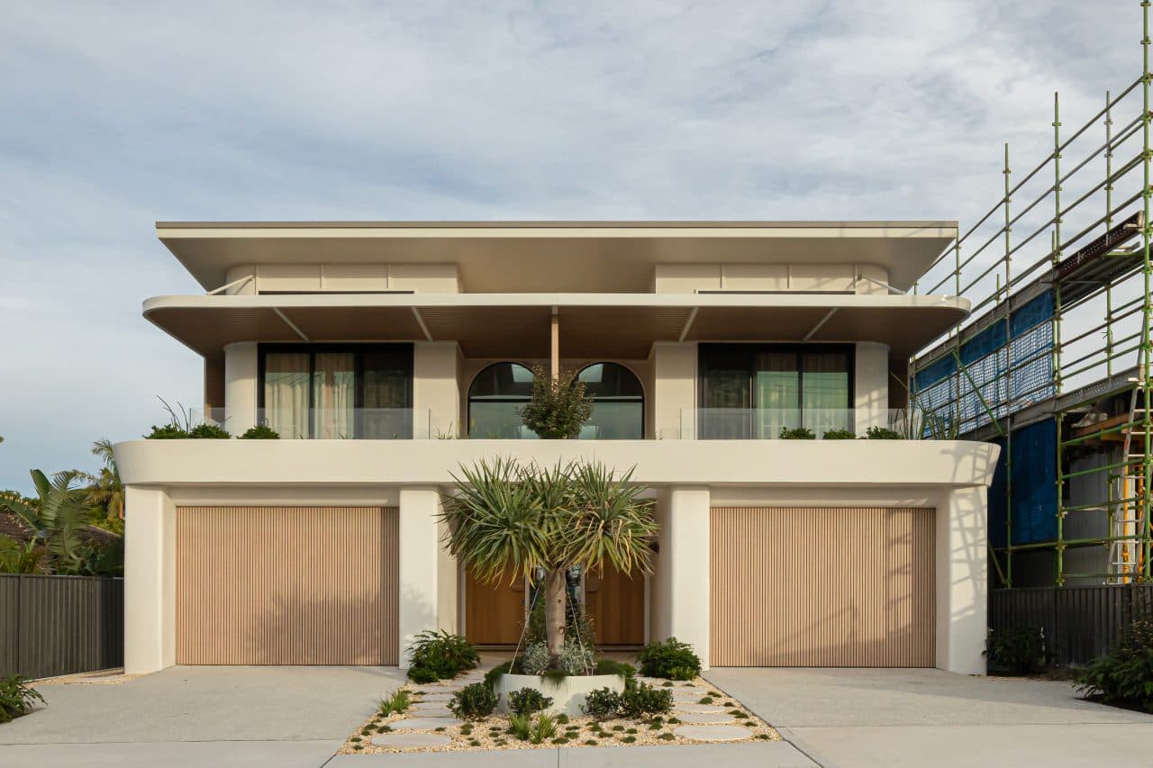 Modern coastal home development with adjacent build under construction