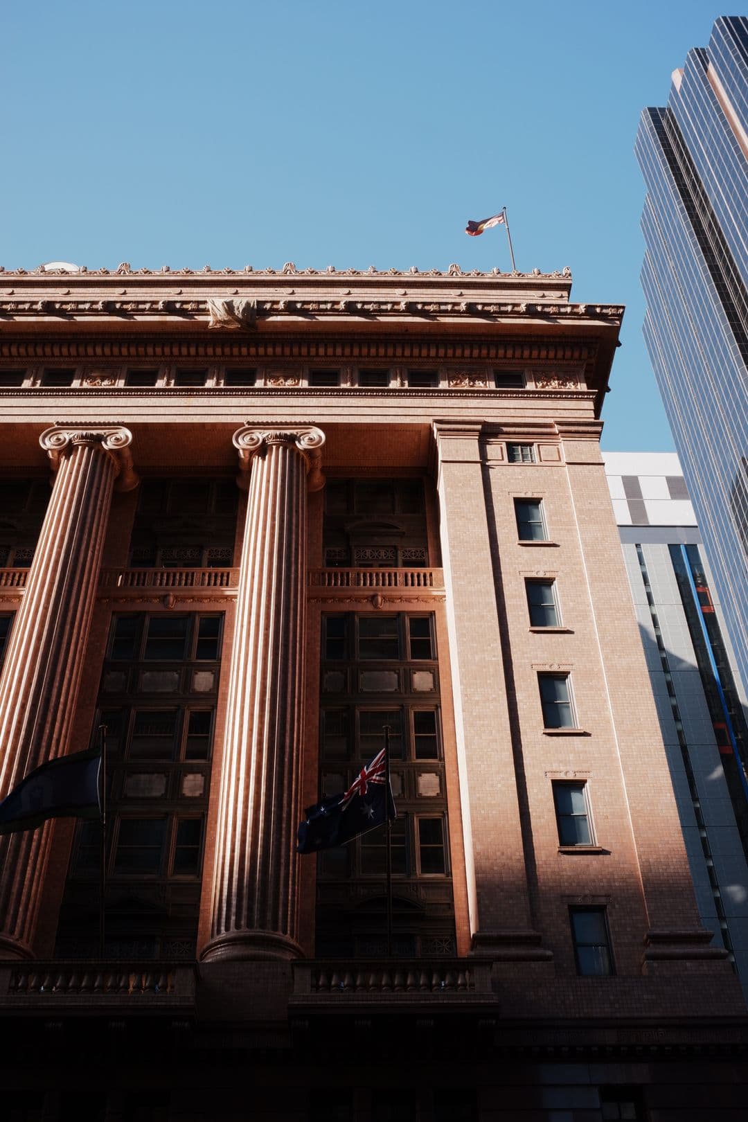 Historic Melbourne CBD building with Australian flags