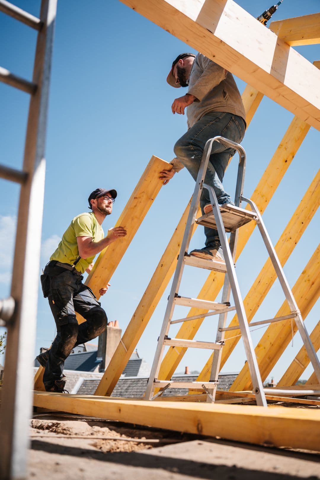Builder working on a new home timber frame